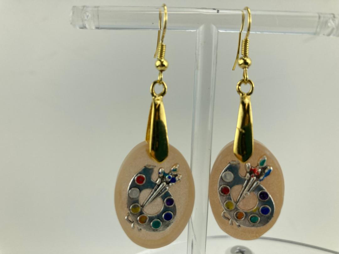 Oval shaped earrings with artist palatte charm