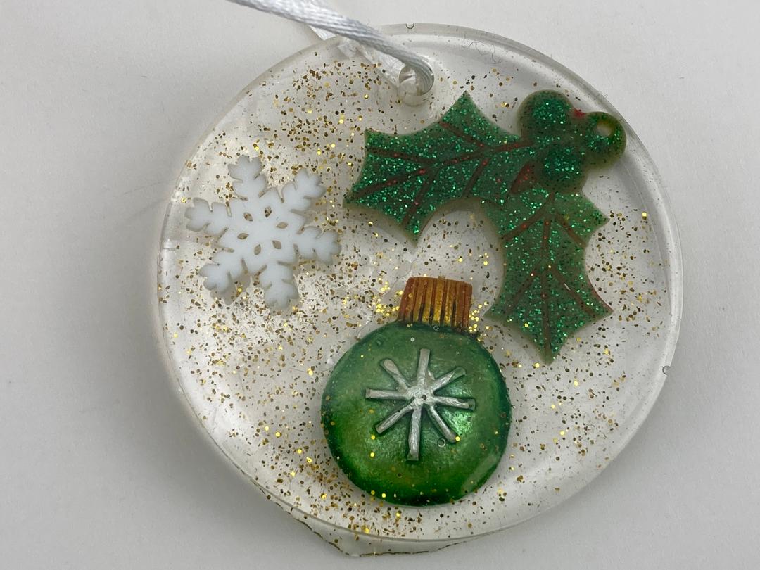 Round Christmas Ornament with snowflake, holly and sparkle