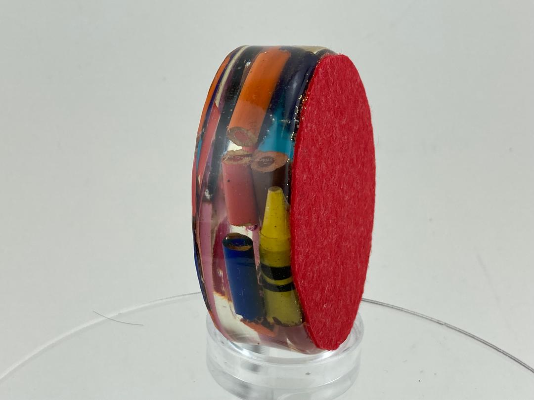 Oval paperweight with red felt backing